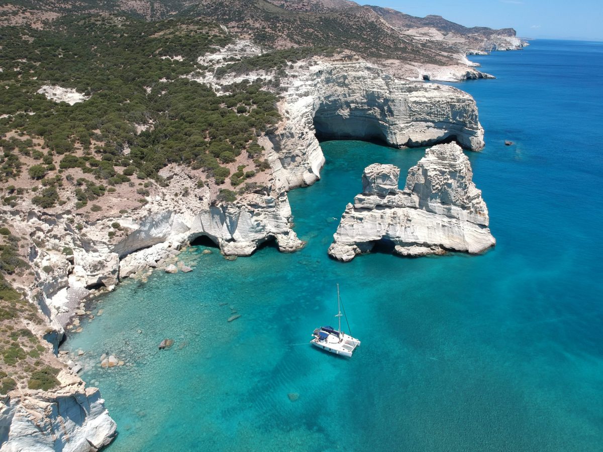 Take a sailing trip to Kleftiko and explore its caves Polco Catamaran achored in a bay in Kleftiko Milos