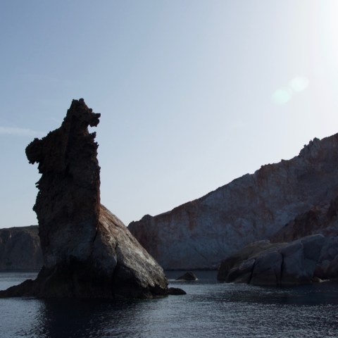 a body of water with a mountain in the background