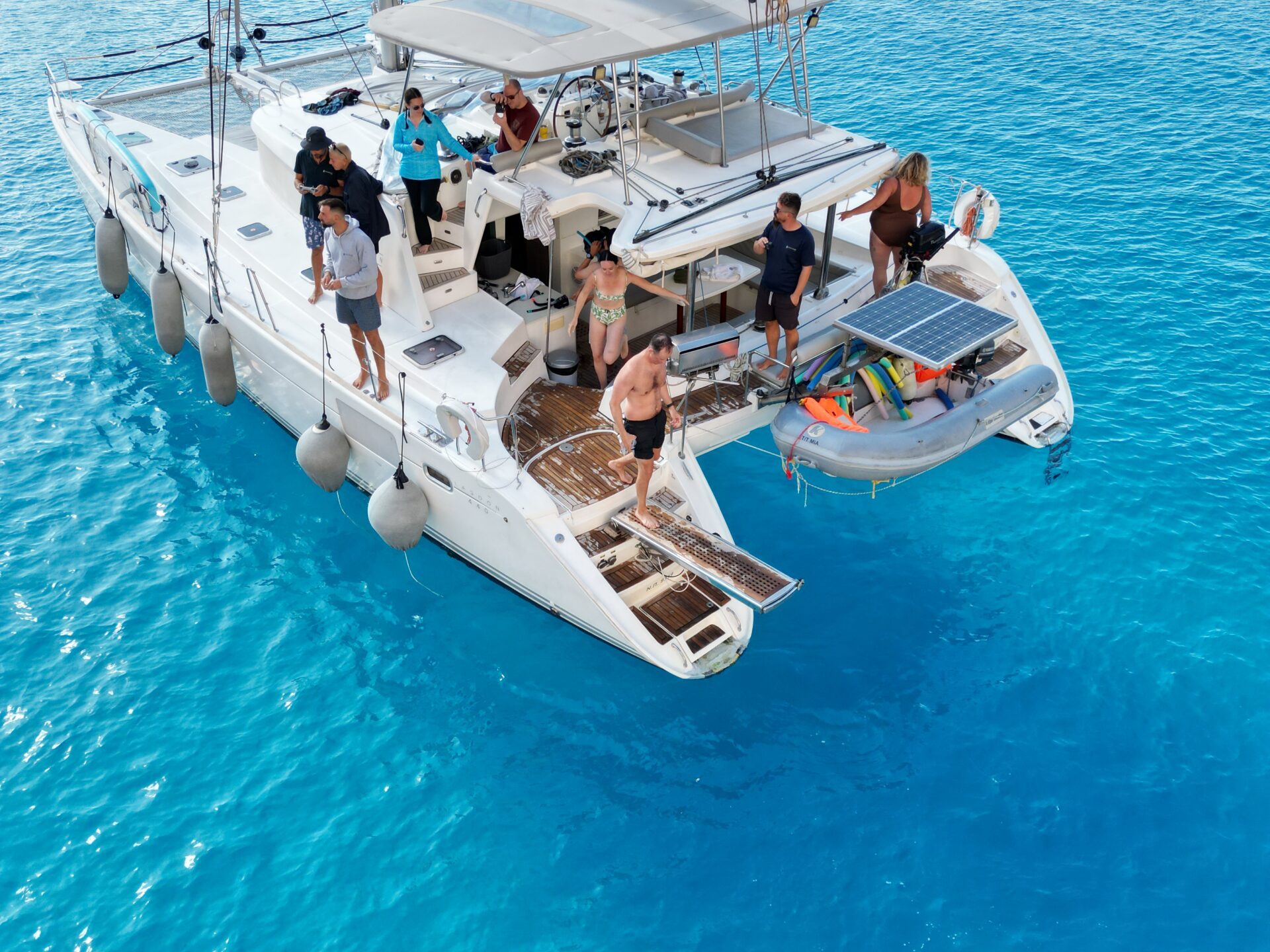 a blue and white boat sitting next to a body of water