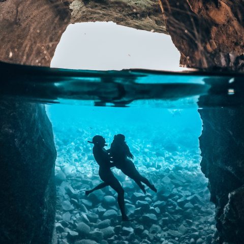 Underwater photo of a couple in Sykia cave in Milos on a Polco sailing cruise