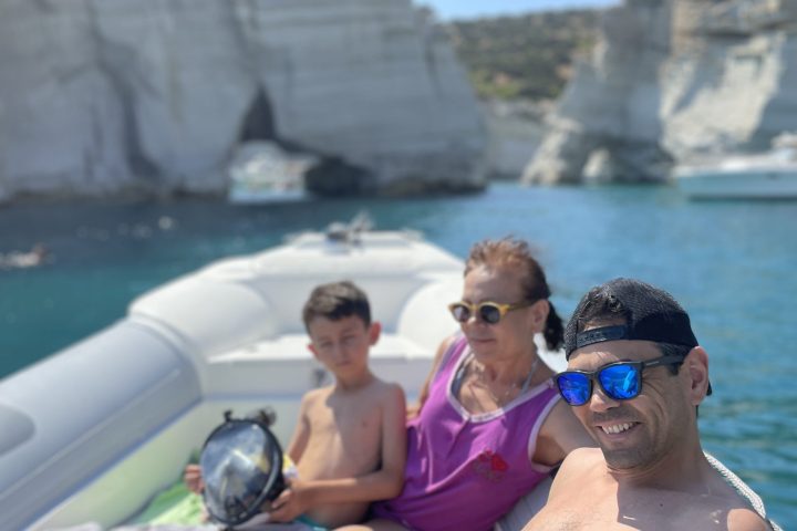 a group of people sitting at a beach