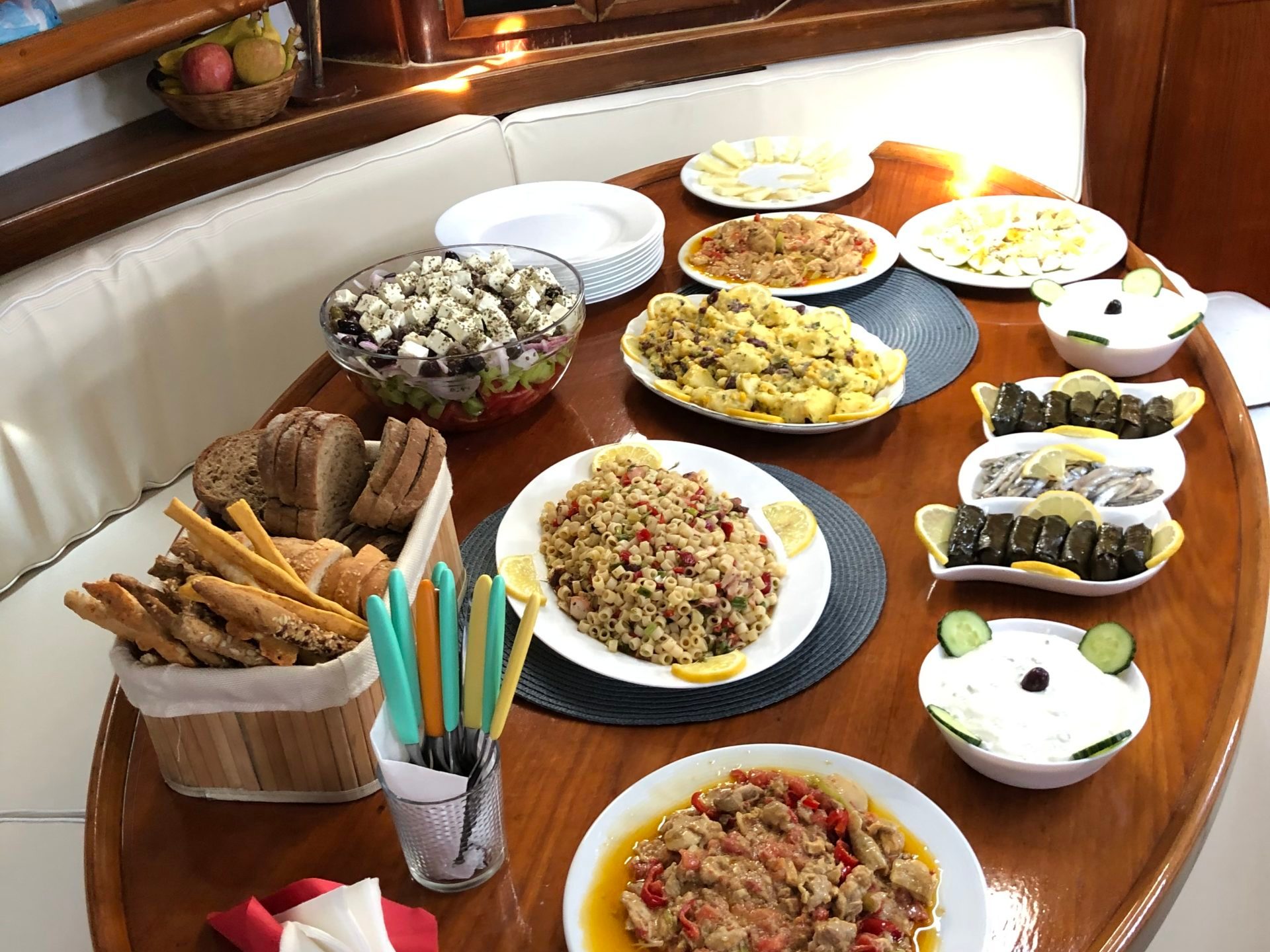 a wooden table topped with plates of food on a plate