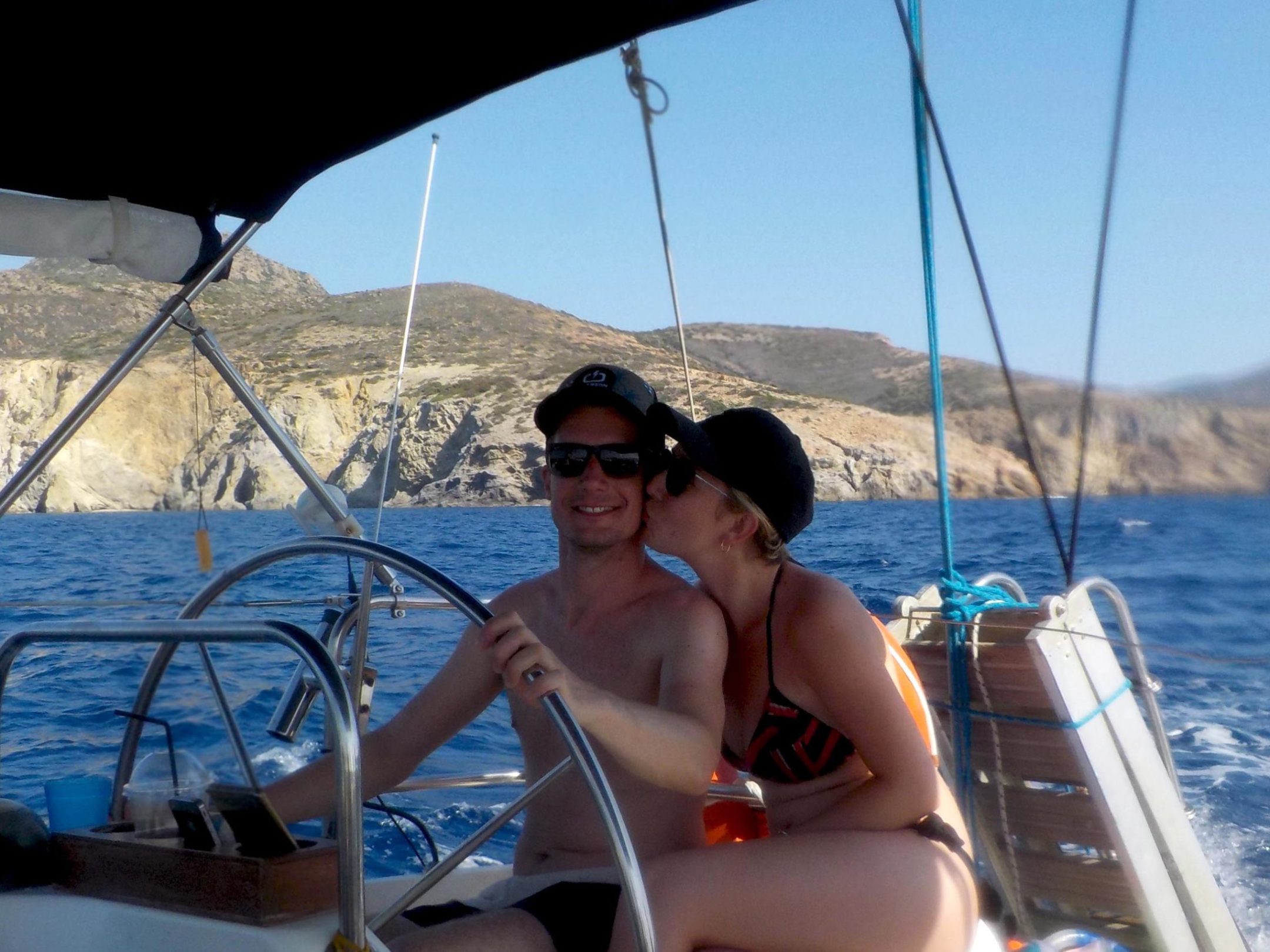 a person sitting on a dock next to a body of water