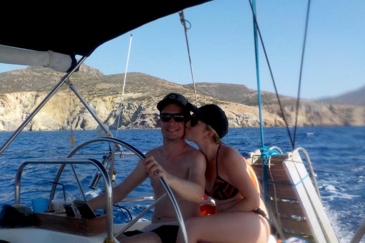 a person sitting on a dock next to a body of water