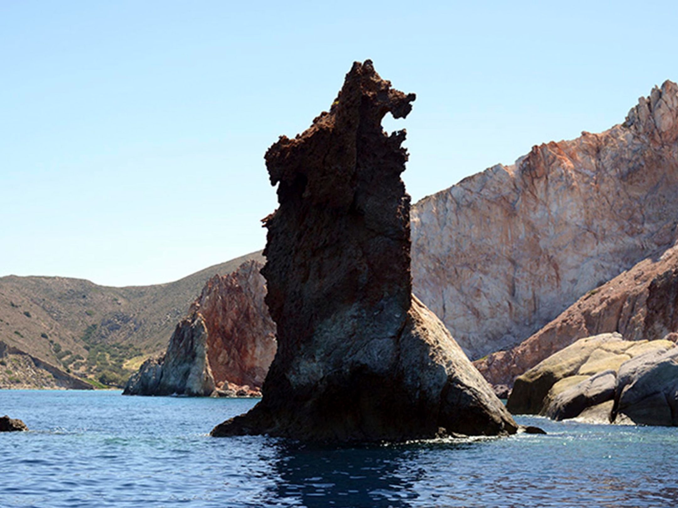 The Arkoudes rock in the east entrance of the bay of Adamas