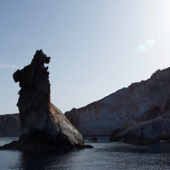 a body of water with a mountain in the background