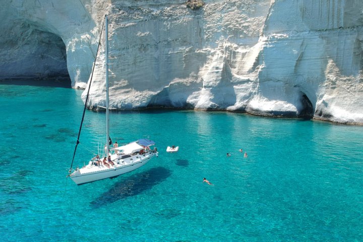 One of our sailing boats anchored in Kleftiko in crystal clear waters