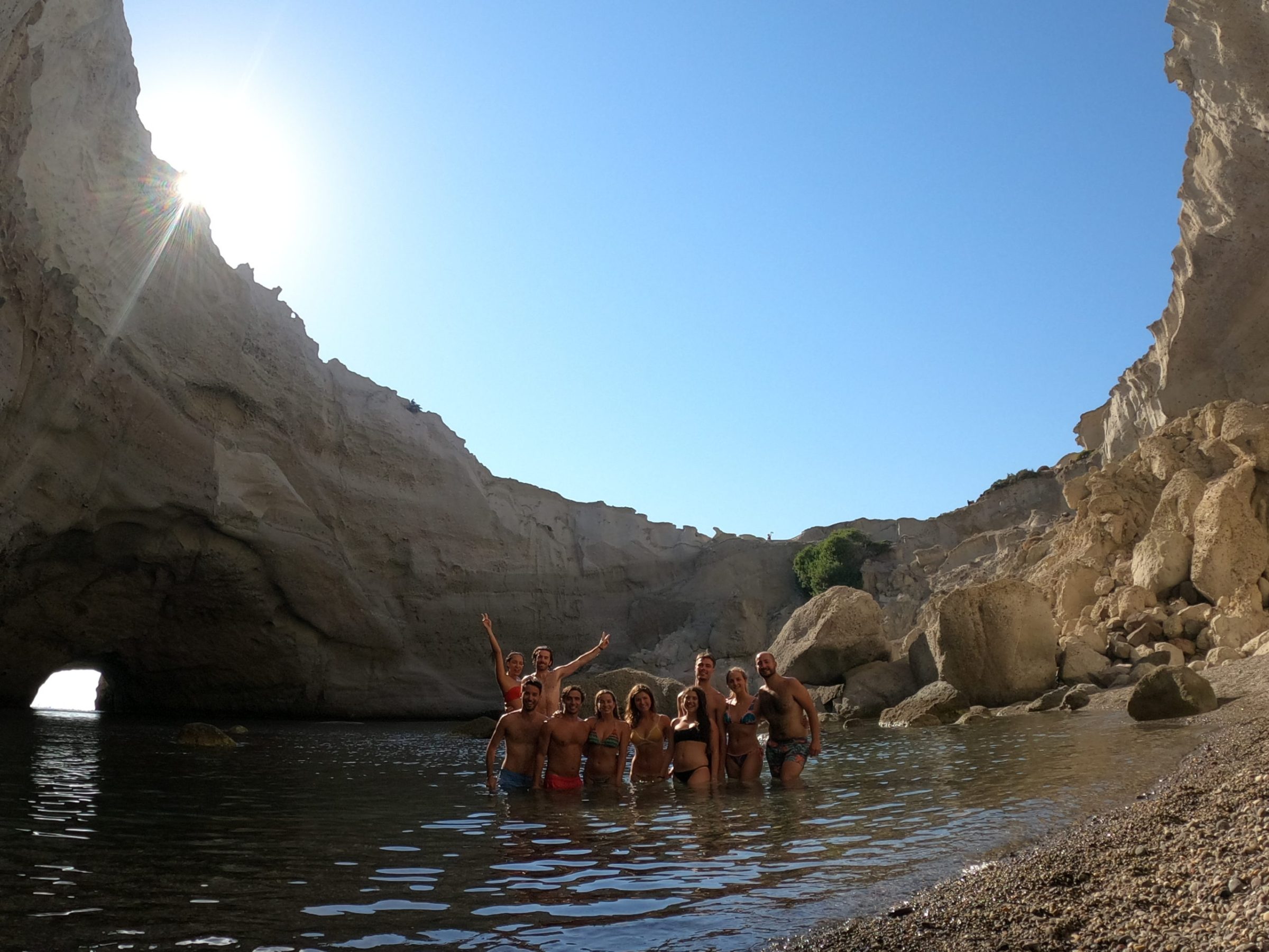 A group photo inside the cave of Sykia on a Polco sailing cruise