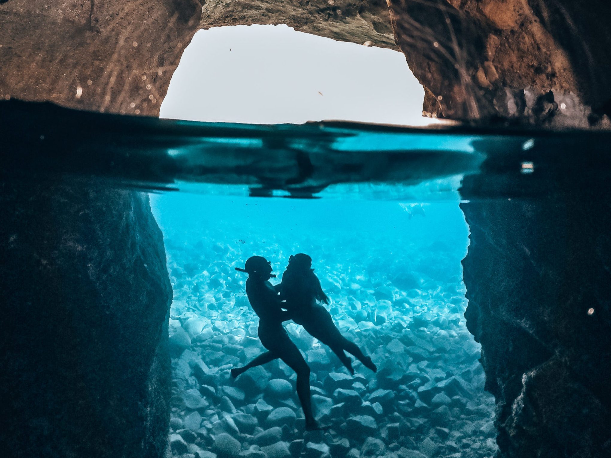 Underwater photo of a couple in Sykia cave in Milos on a Polco sailing cruise