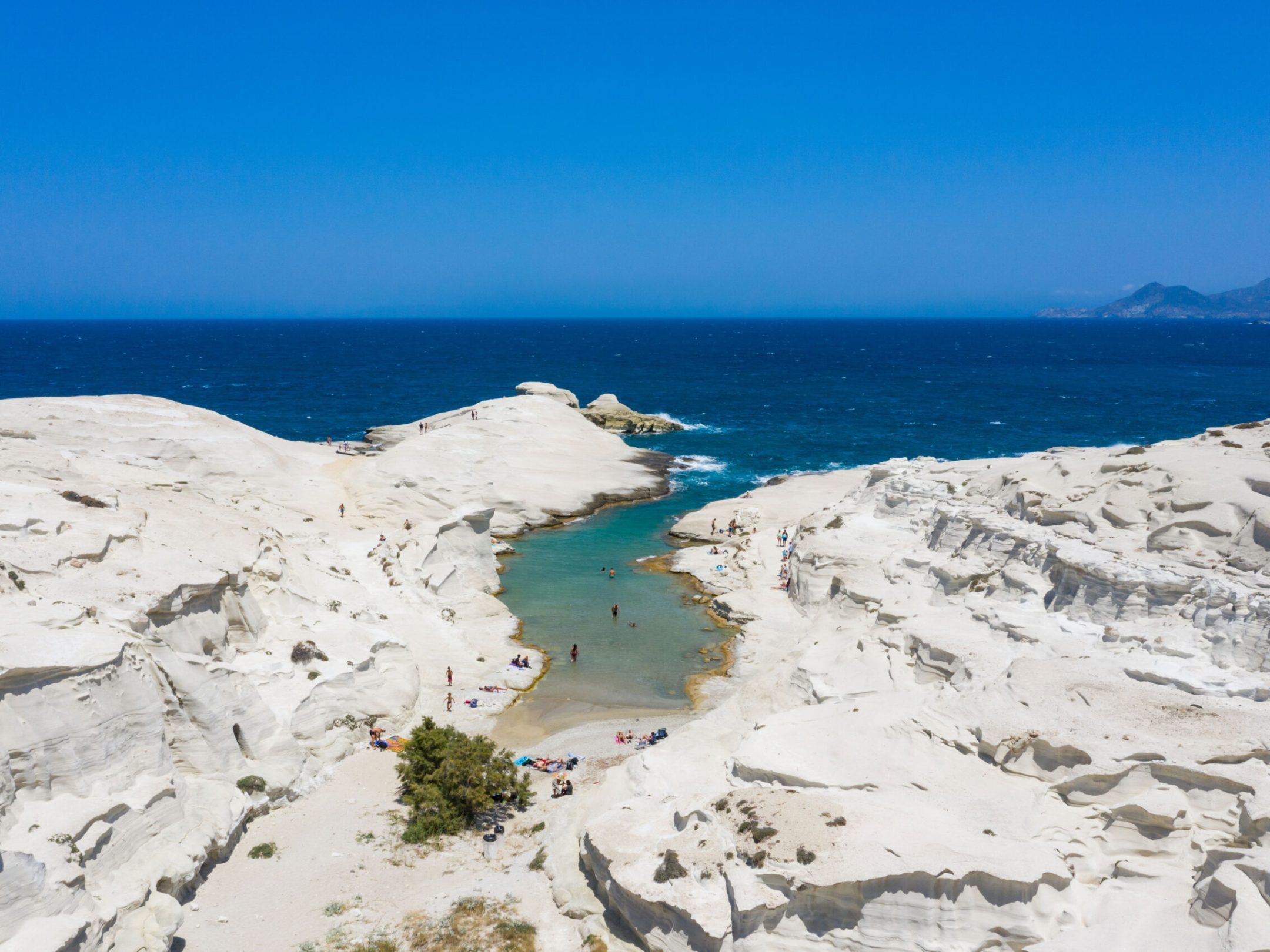 a sandy beach next to the ocean